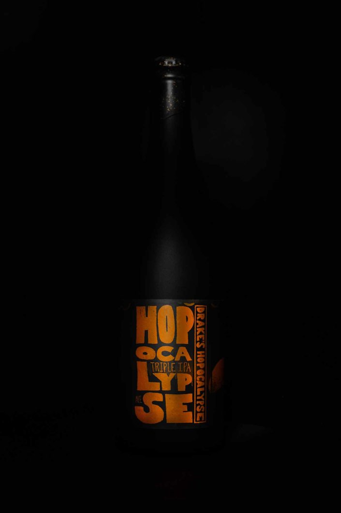 A bottle of Hopocalypse Triple IPA by Drake's Brewing