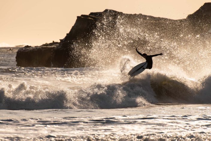 Surfer at Año Nuevo Reserve Flying Off a Wave