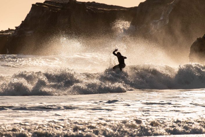 Surfer at Año Nuevo Reserve with knees ben in Whitewater